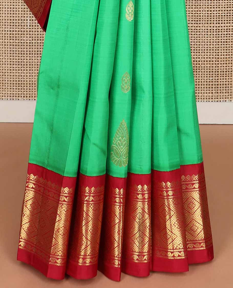 Green buttas kancheepuram silk saree with contrast korvai border of thilakam mokku, banaras design & floral pallu