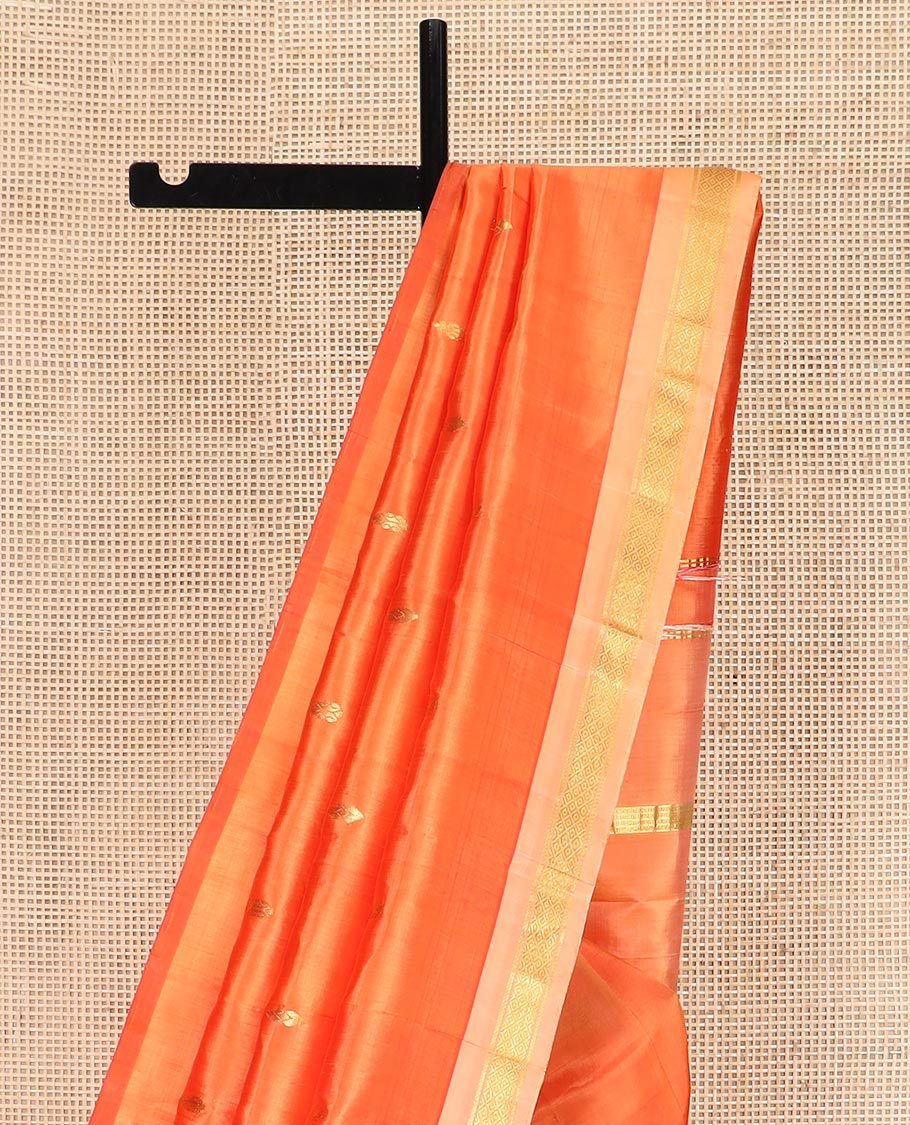 Orange Kanchipuram Silk Saree Beautified with Zari Buttas All Over Its Body, Complemented by a Contrast One-Sided Border of Banaras, and Mayil Kann Designs, Pallu of Zari Stripes, and Comes Without a Blouse