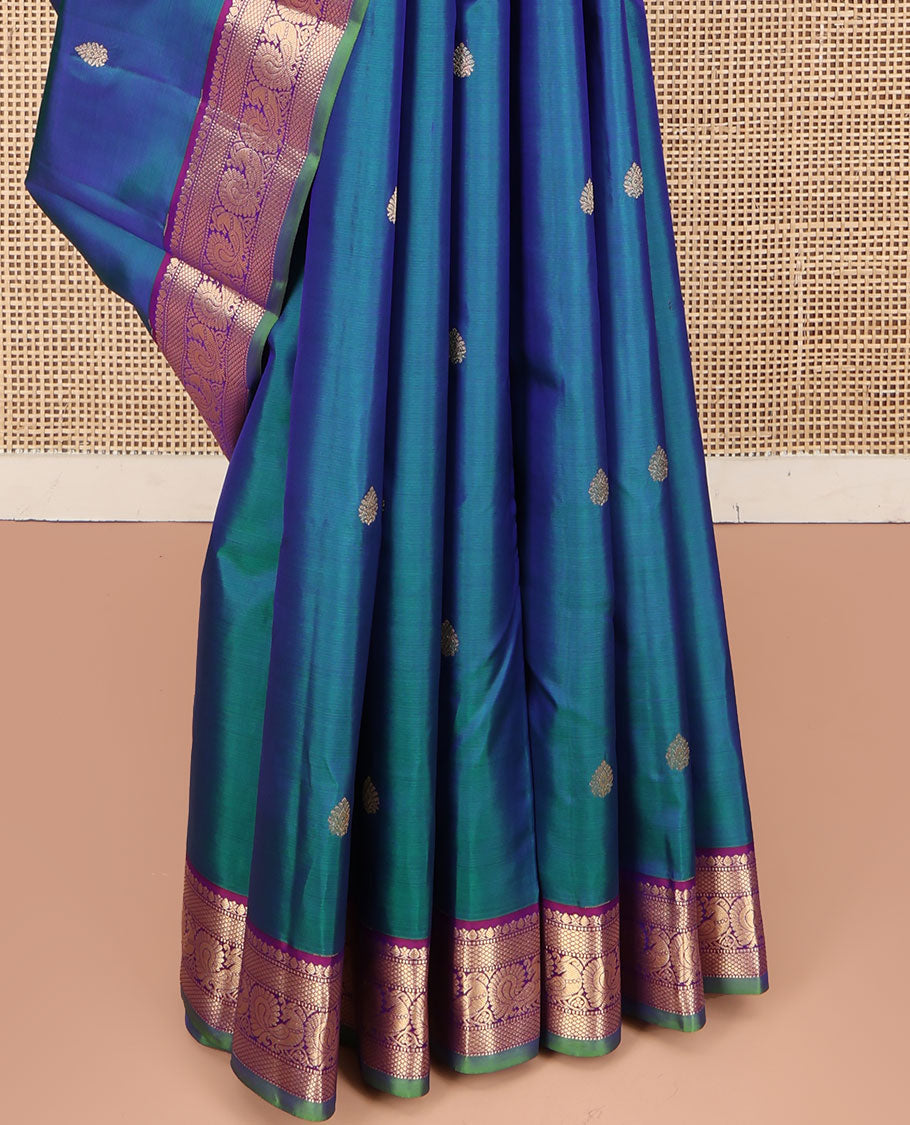 Blue Kanchipuram Silk Saree, Mesmerized with Zari Buttas All Over Its Body, Complemented by a Contrast Border of Thilakam, Mayil Kann, Muthu, and Mayil Designs, Grand Jaal Pallu, and Paired with a Contrast Blouse