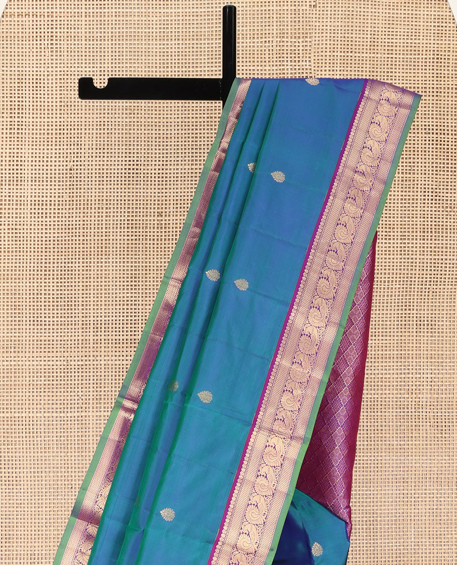 Blue Kanchipuram Silk Saree, Mesmerized with Zari Buttas All Over Its Body, Complemented by a Contrast Border of Thilakam, Mayil Kann, Muthu, and Mayil Designs, Grand Jaal Pallu, and Paired with a Contrast Blouse