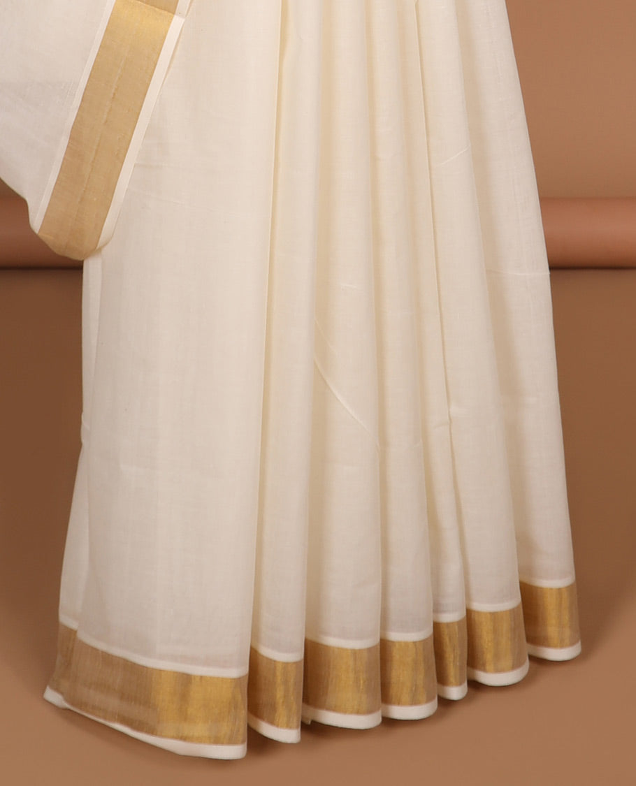 Cream kerala saree with zari designs, plain border & pallu of intricate designs