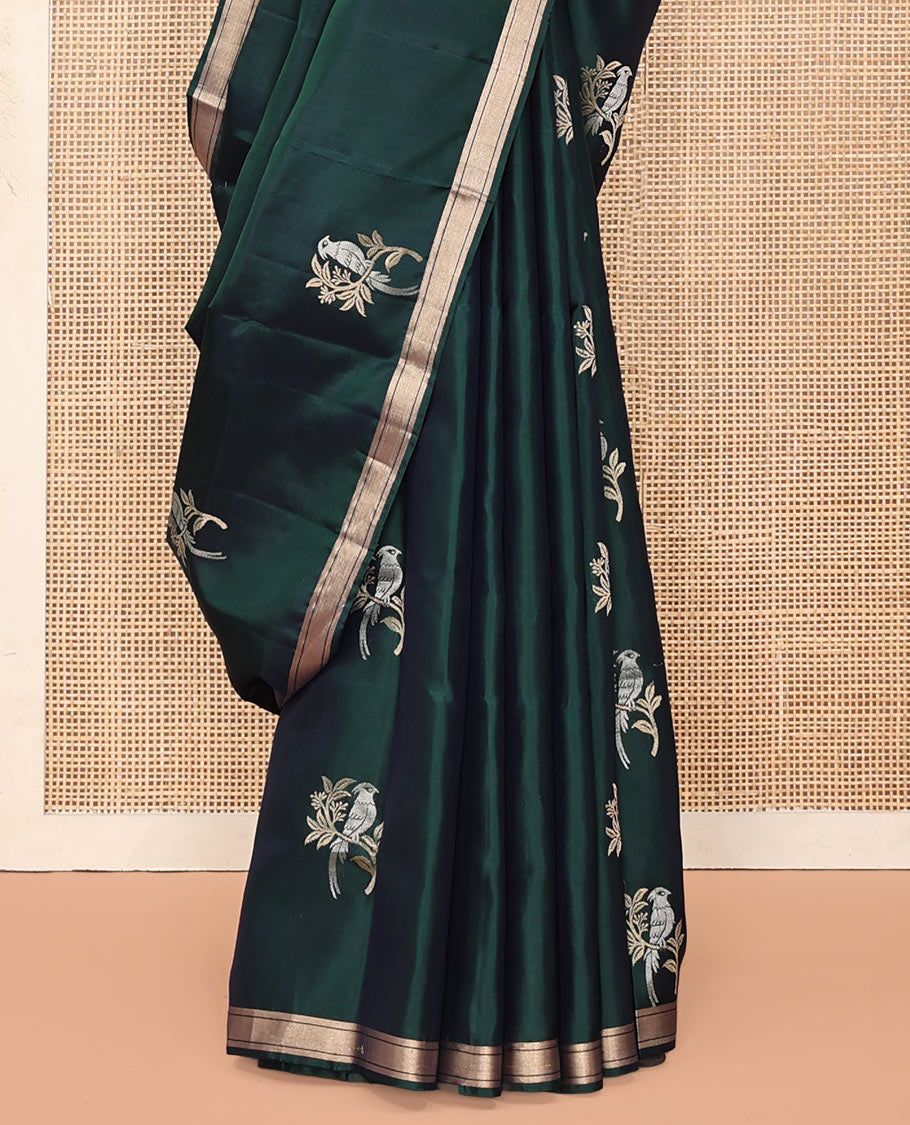Green Mayuri Soft Silk Saree, Bedecked with Bird Buttas All Over Its Body, Highlighted by Zari Piping Border, Pallu of Floral Jaal and Bird Designs, and Paired with a Matching Blouse