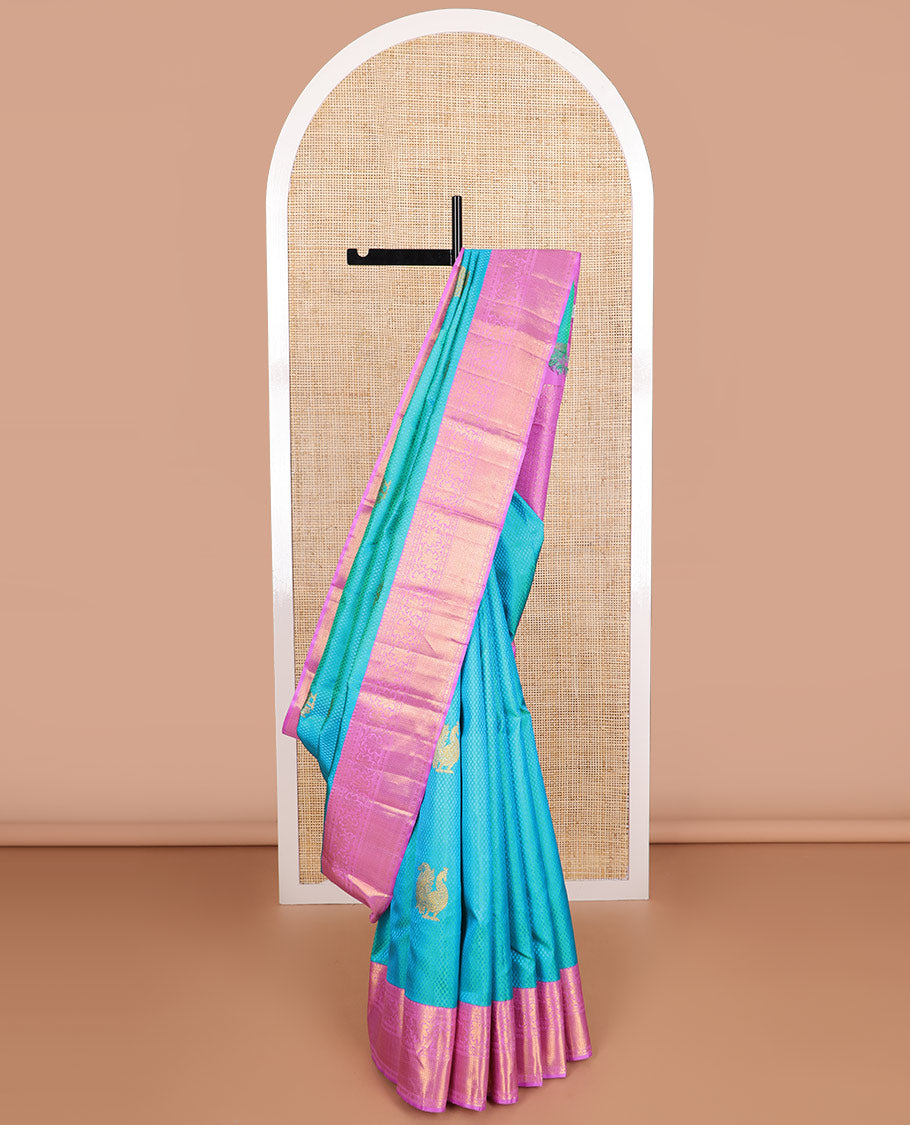 Light blue checked, mayil buttas silk saree with contrast border of thilakam mokku, muthu, paun design & floral design pallu
