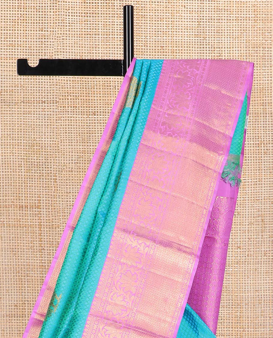 Light blue checked, mayil buttas silk saree with contrast border of thilakam mokku, muthu, paun design & floral design pallu