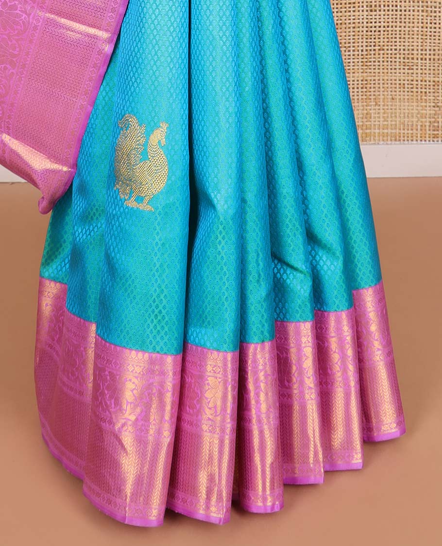 Light blue checked, mayil buttas silk saree with contrast border of thilakam mokku, muthu, paun design & floral design pallu