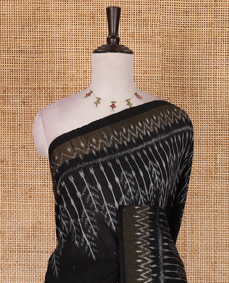 Black buttas and floral like ikkat woven ikkat cotton saree, zari bavanji border, ikkat design pallu, and plain blouse