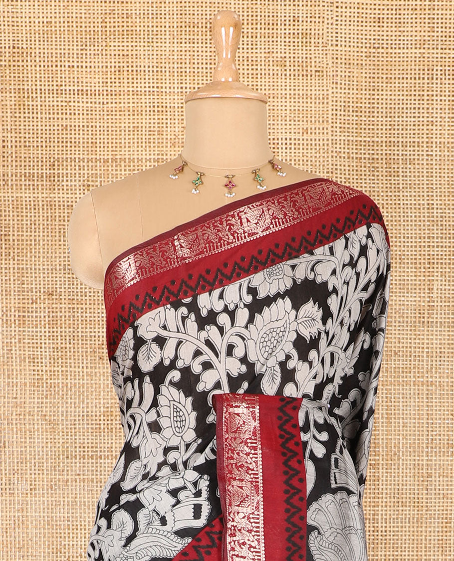 Black kalamkari floral vine and peacock printed muslin cotton saree, contrast zari border, kalamkari peacock printed pallu, and a contrast coin buttas printed blouse