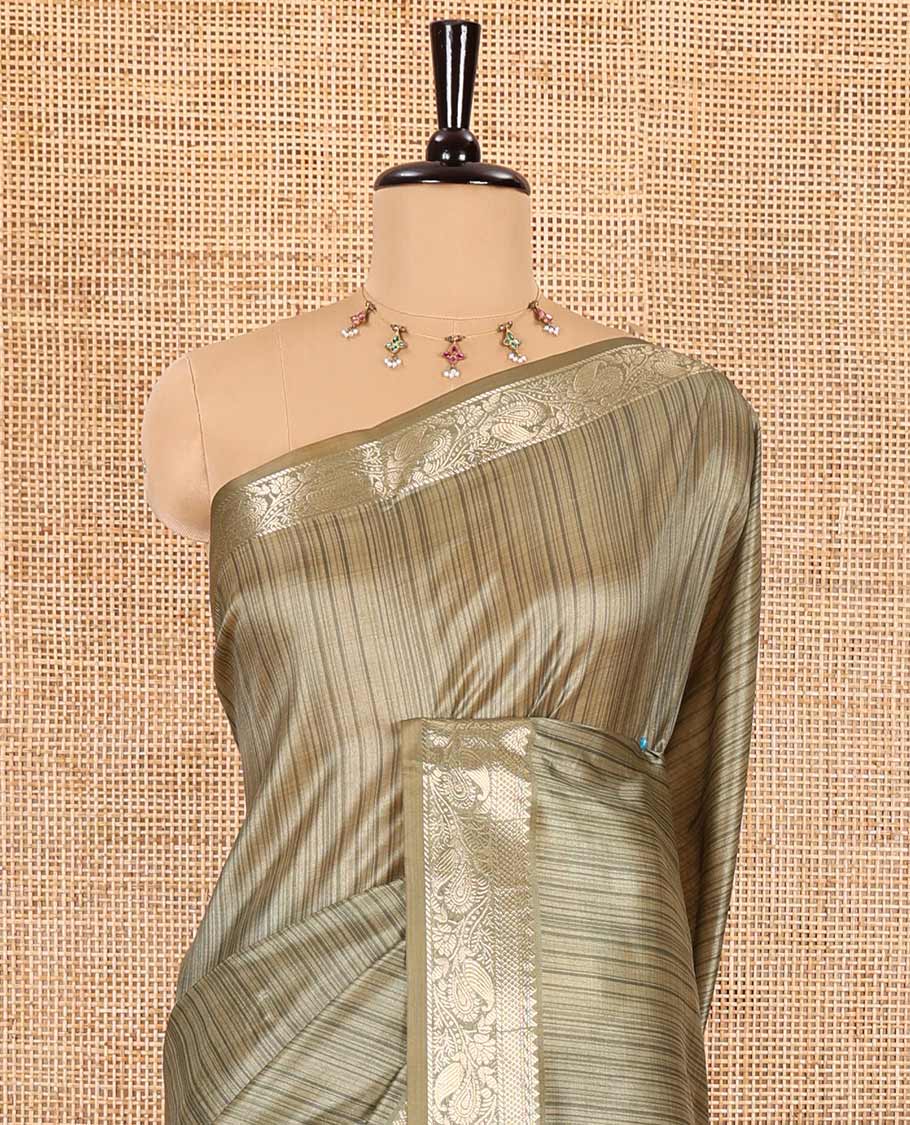 Olive green striped semi-tussar saree, traditional zari border of floral creeper designs, contrast pallu of Pichwai cow print, and contrast Pichwai cow printed blouse