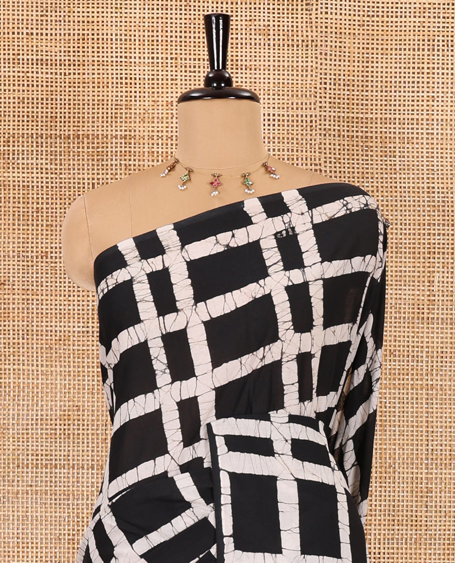 Black checked batik printed mul cotton saree, contrast kaleidoscope colored batik printed pallu, and a contrast batik printed blouse