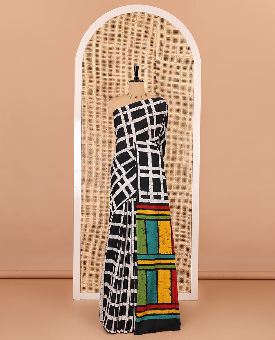 Black checked batik printed mul cotton saree, contrast kaleidoscope colored batik printed pallu, and a contrast batik printed blouse