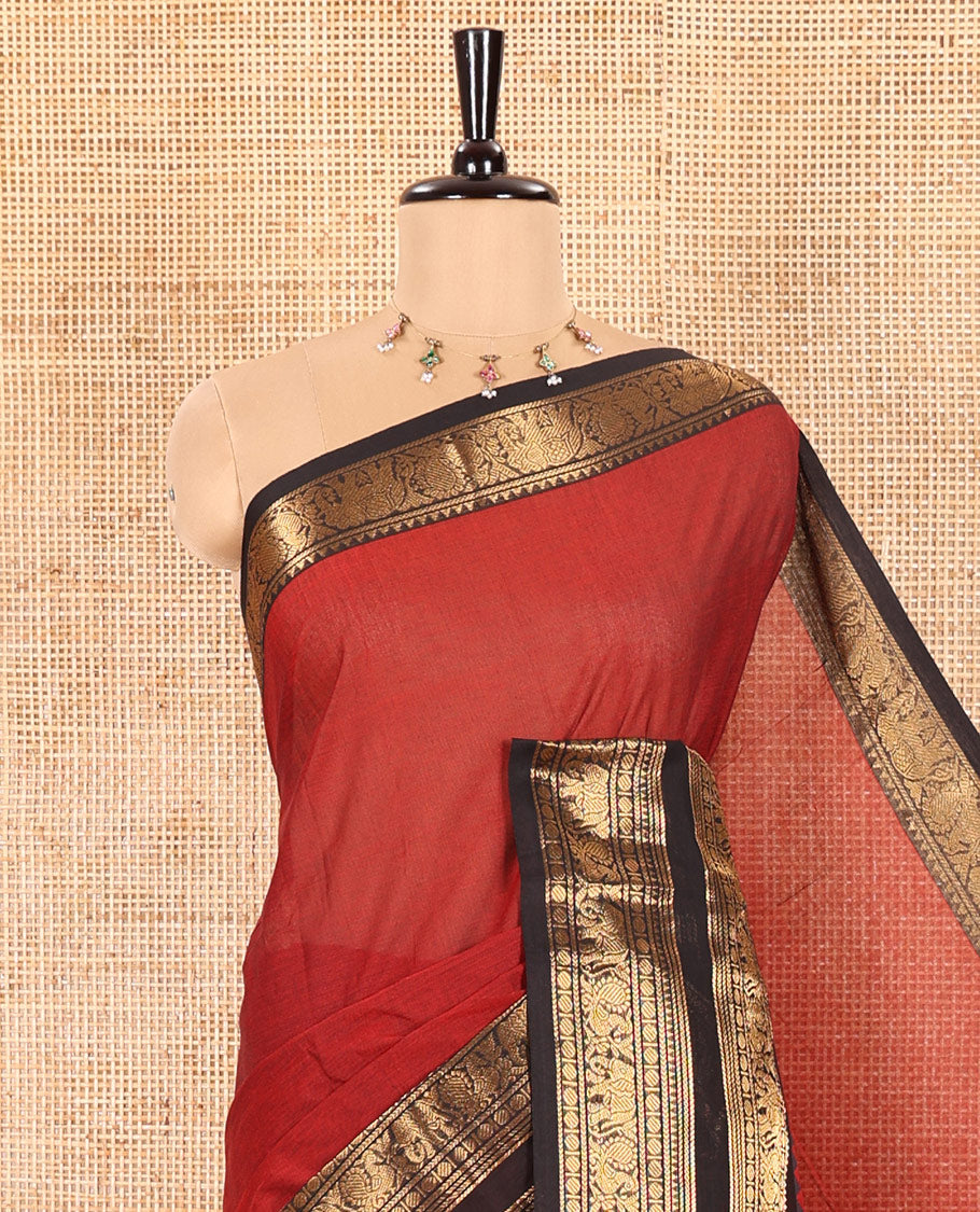Maroon Plain Chettinad Cotton Saree Adorned with a Contrasting Temple Rettai Pettu Border of Peacock-Elephant Motifs, a Subtle Pallu of Stripes, and a Matching Blouse