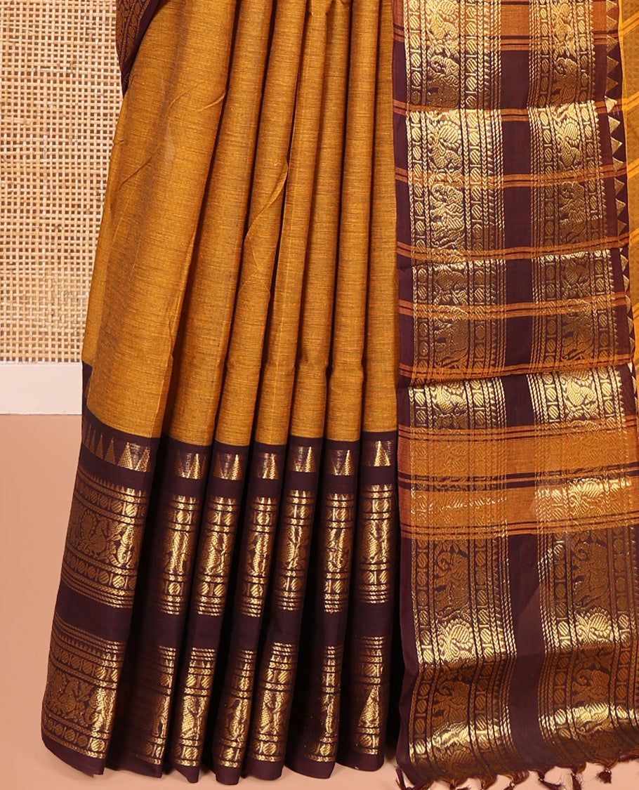 Mustard Plain Chettinad Cotton Saree, Complemented by a Contrast Rettai Pettu Zari Maroon Border of Temple, Coin, Elephant, and Peacock Designs, Subtly Striped Pallu, and Paired with a Matching Blouse