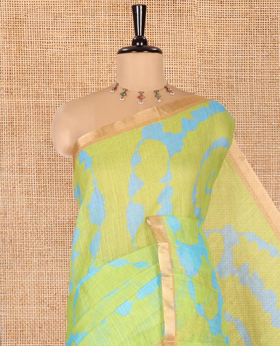Parrot Green Linen Cotton Saree, Adorned with Shibori Print On Its Body, Subtle Piping Border, Pallu Steeped with Floral Vine Print, and Paired with a Printed Blouse