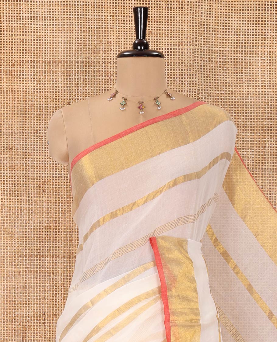 Cream Khadi Mul Cotton Saree, Gleamed up with Zari Stripes All Over Its Body, Subtle Gold Zari Border, Self-Pallu with Tassels, and Paired with a Matching Blouse