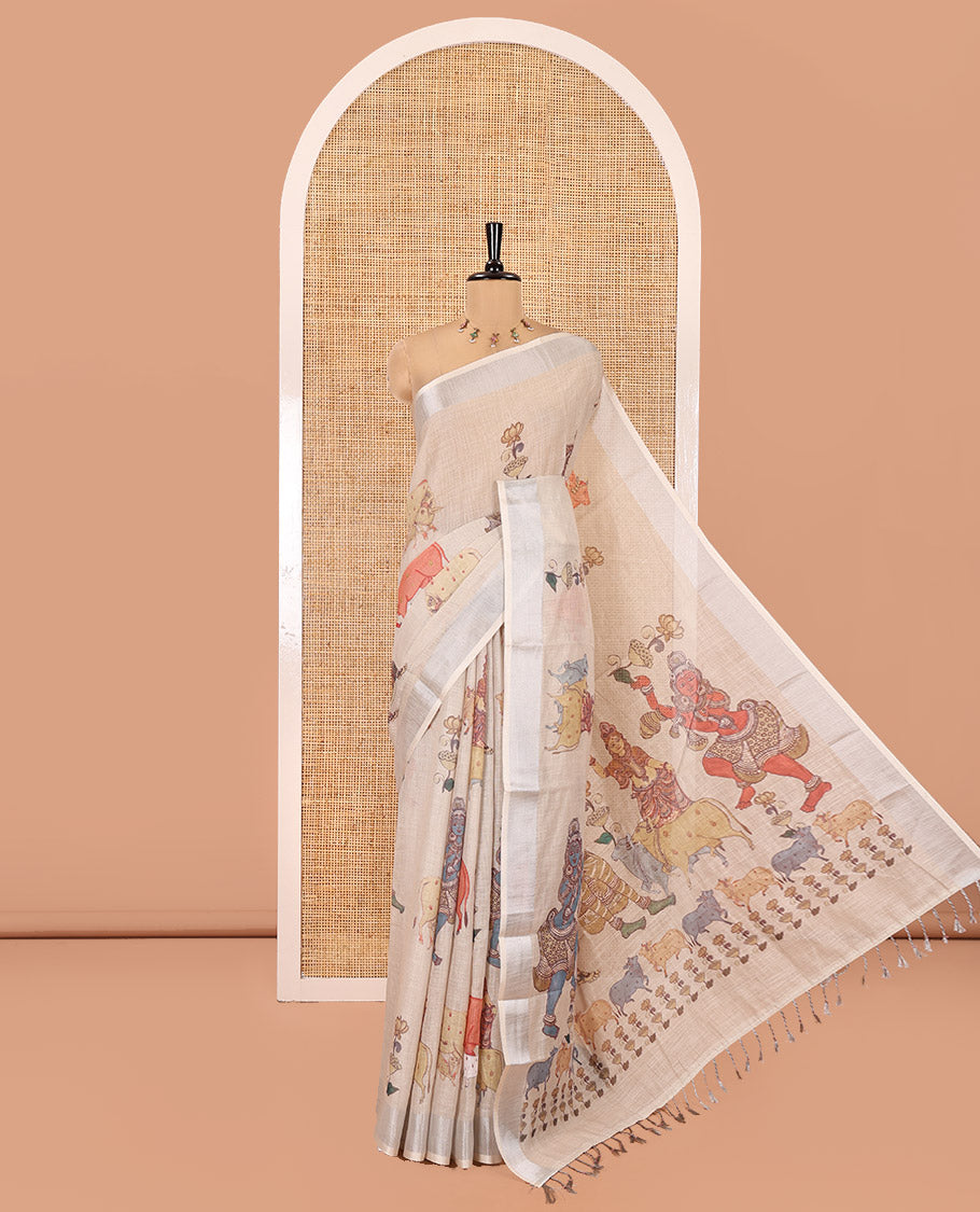 Cream Linen Saree Features Ancient Human Figurines, Floral, and Pichwai Cow, a Zari Border, Kalamkari Pallu, and Matching Blouse