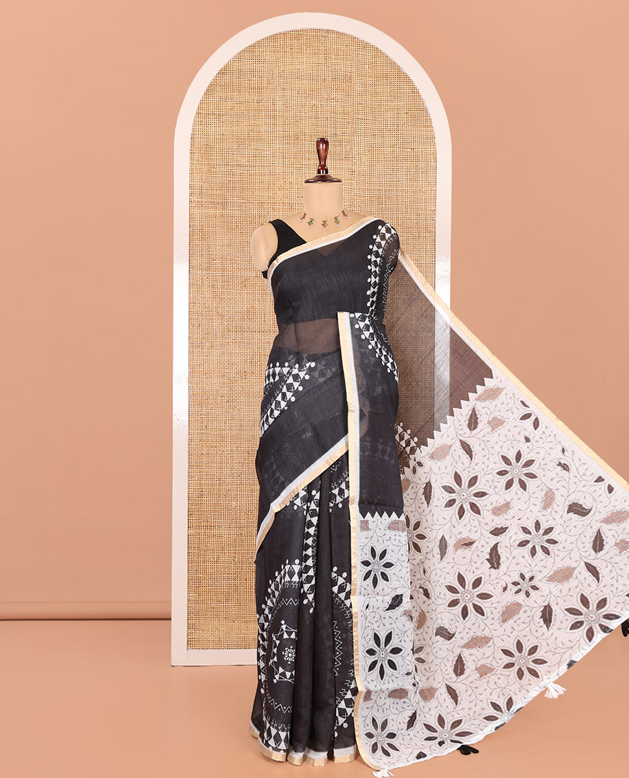 Black Orange Linen Cotton Saree Features Warli Print, a Contrast Piping Border, a Floral-Printed Pallu, and a Contrast Blouse
