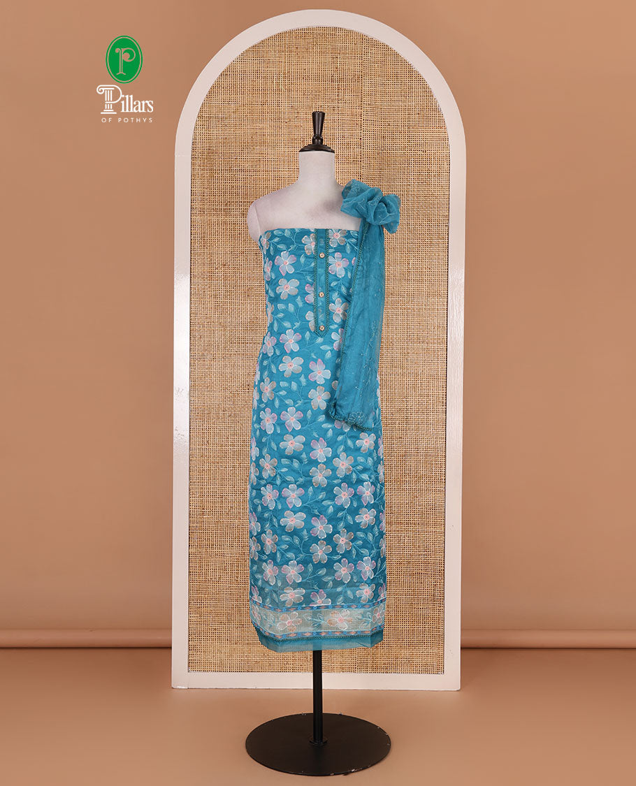 Blue churidar material set, floral print with thread outlined organza top, plain santoon bottom, and floral vine sequins embroidered organza dupatta