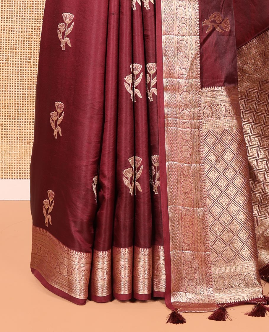 Wine Semi-Banaras Satin Silk Saree, Prettified with Floral Zari Buttas Across Its Body, Highlighted by Traditional Zari Design Border, Grand Zari Woven Palu of Jaal Designs, and Paired with a Matching Blouse