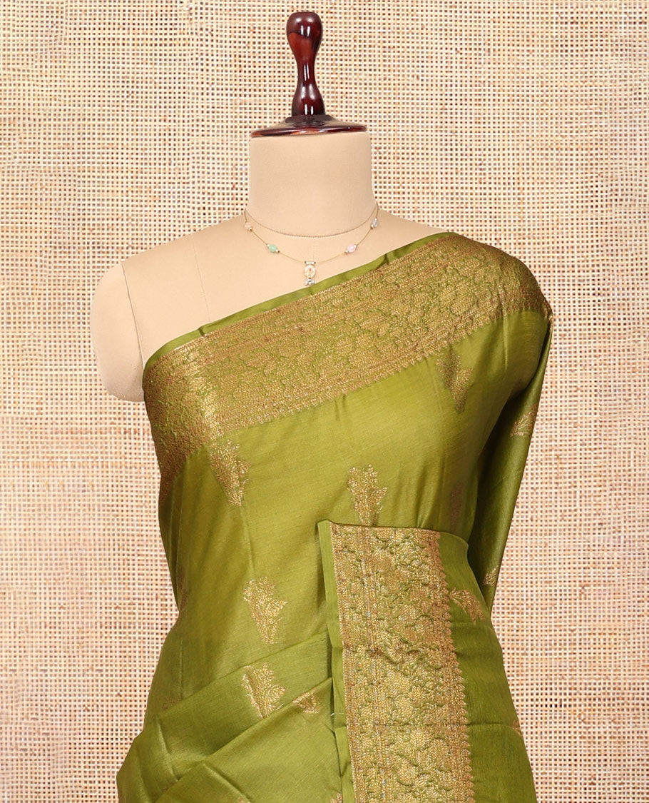 Green Tussar Silk Saree Features Zari Buttas, Highlighted by a Zari Border, Intricately Designed Pallu, and a Matching Blouse
