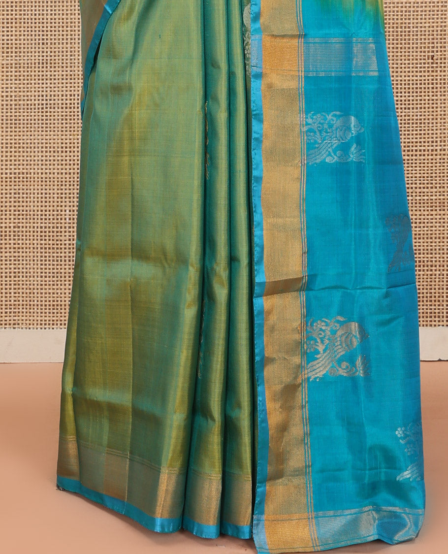 Green Uppada Silk Saree Beautified with Parrot Buttas All Over Its Body, Complemented by Bavanji Border, Captivating Pallu Depicting the Same Parrot Motifs, and Paired with a Contrast Blouse
