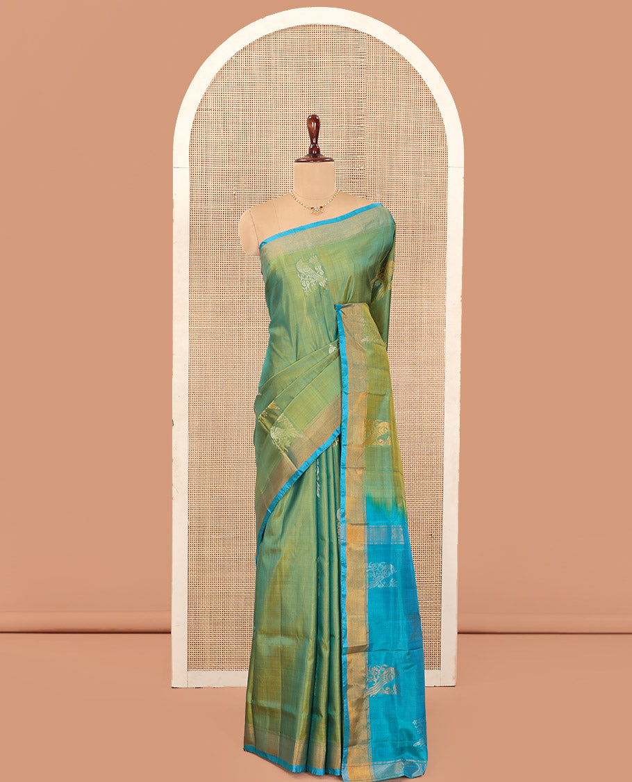 Green Uppada Silk Saree Beautified with Parrot Buttas All Over Its Body, Complemented by Bavanji Border, Captivating Pallu Depicting the Same Parrot Motifs, and Paired with a Contrast Blouse