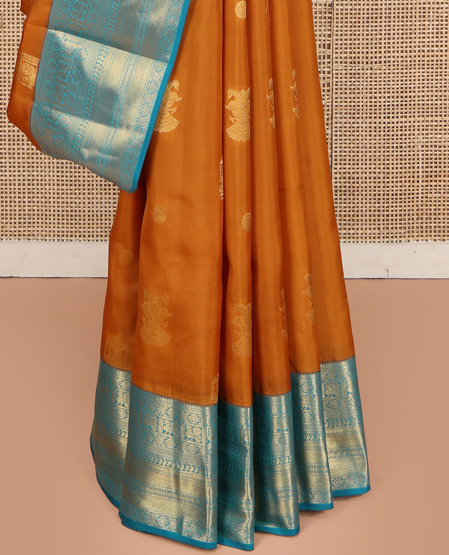 Orange Vasundhara Lite Silk Mix Saree, Detailed with Mayil, Chakra, and Iruthalai Pakshi Buttas, Complemented by Contrast Border of Thilakam Mokku, Mayil, Manga, Vanki, and Mayil Kann Designs, Opulently Embellished Jaal Pallu, and a Contrast Blouse