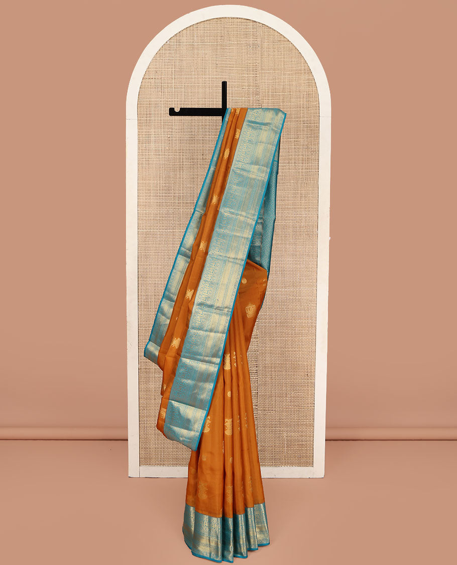 Orange Vasundhara Lite Silk Mix Saree, Detailed with Mayil, Chakra, and Iruthalai Pakshi Buttas, Complemented by Contrast Border of Thilakam Mokku, Mayil, Manga, Vanki, and Mayil Kann Designs, Opulently Embellished Jaal Pallu, and a Contrast Blouse