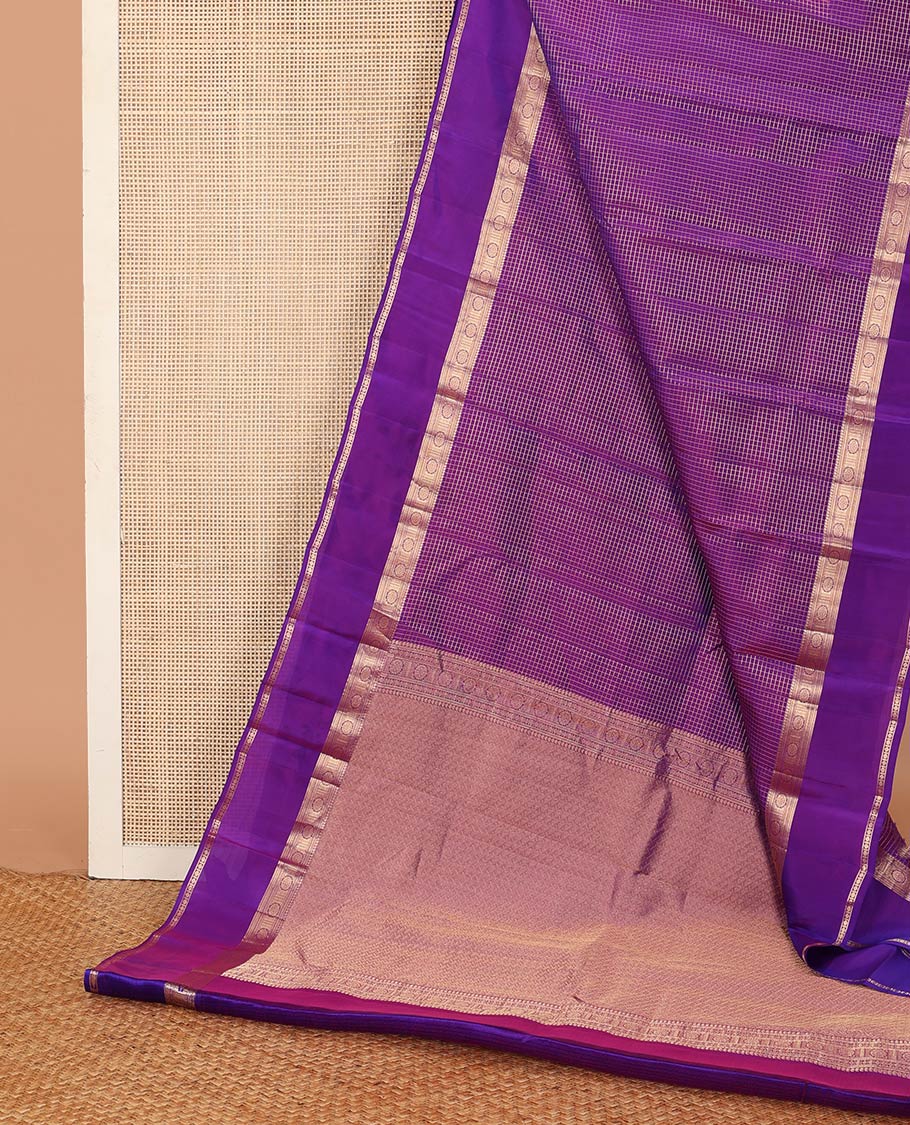 Purple zari checked Vasundhara silk mix saree, zari rettai pettu border of manga, muthu, banaras, and laddu kamalam designs, and intricate pallu