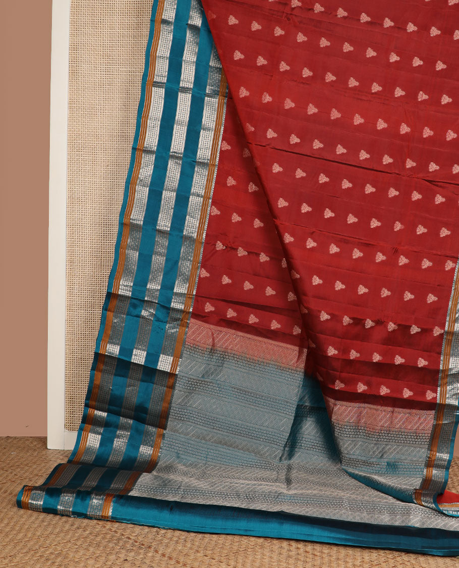 Rust zari buttas silk saree, contrast border of manga mokku,muthu,kathir & rudraksham motifs & geometric patterned pallu