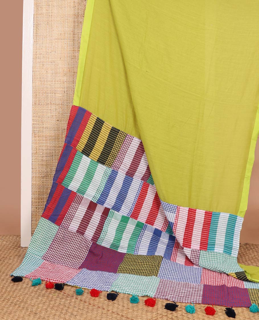 Borderless green plain khadi cotton saree, contrast kaleidoscope-colored patchwork style micro-checked pallu with colorful tassels