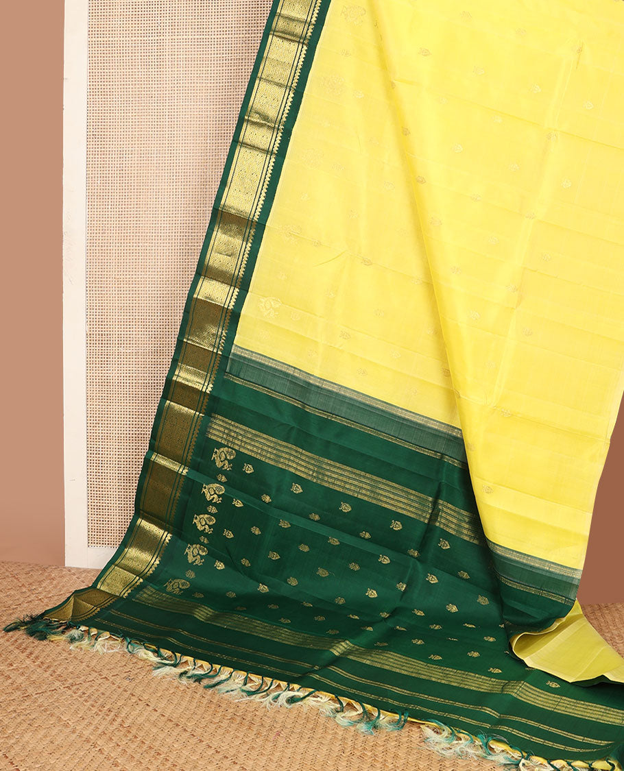 Yellow zari buttas kanchipuram silksaree, contrast one-sided korvai border of salngai & jaal design & mayil design pallu