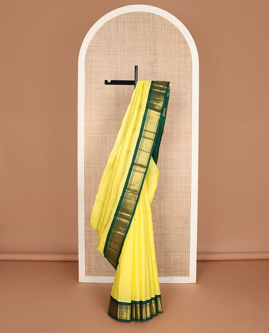 Yellow zari buttas kanchipuram silksaree, contrast one-sided korvai border of salngai & jaal design & mayil design pallu