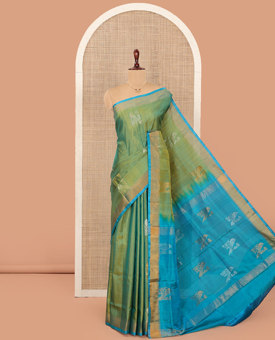 Green Uppada Silk Saree Beautified with Parrot Buttas All Over Its Body, Complemented by Bavanji Border, Captivating Pallu Depicting the Same Parrot Motifs, and Paired with a Contrast Blouse