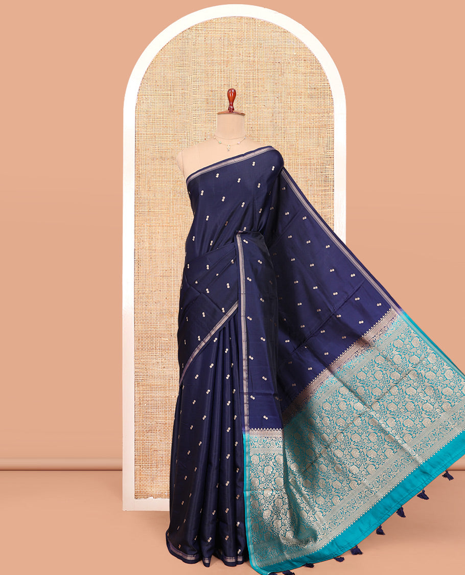 Navy Blue Satin Silk Saree, Delicately Woven with Buttas All Over Its Body, a Subtle Piping Border, Complemented by a Contrast Pallu of Floral-Paisley Designs in Zari, and Paired with a Contrast Blouse