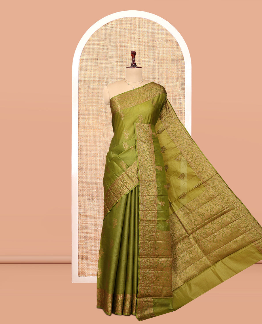 Green Tussar Silk Saree Features Zari Buttas, Highlighted by a Zari Border, Intricately Designed Pallu, and a Matching Blouse