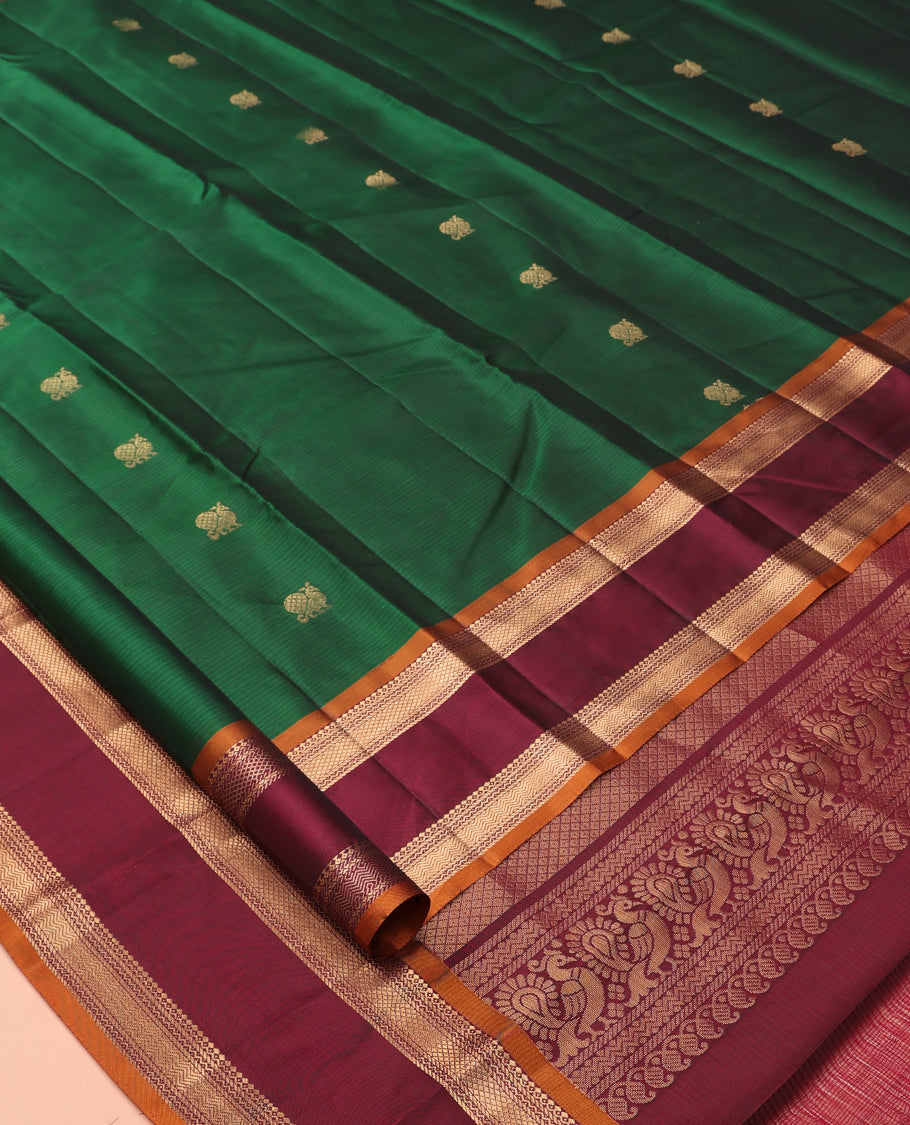 Green Vasundhara Lite Silk Mix Saree Features Mayil Buttas and Stripes, a Contrast Rettai Pettu Border of Salngai, Banaras, Neli, Kuyil, Kann, and Vanki Designs, Mayil Kann Pallu, and a Contrast Blouse
