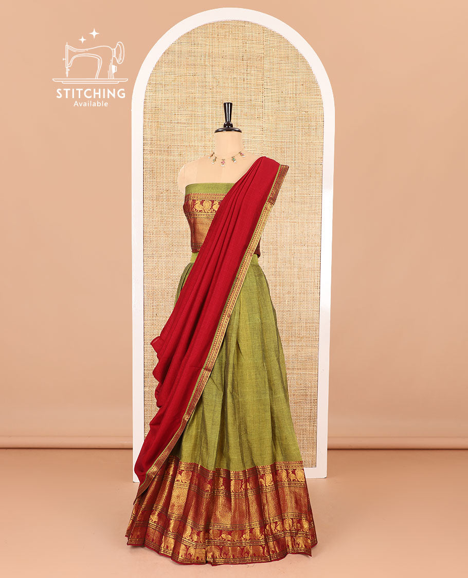 Green half-saree, plain with big contrast traditional zari motifs steeped border skirt, matching blouse and a plain zari border contrast dhavani