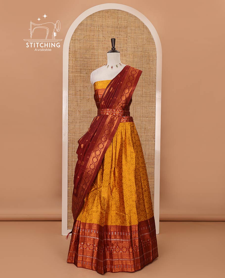 Mustard semi-banaras half-saree, embossed & contrast traditional zari border skirt,blouse of embossed & zari work & contrast-maroon zari design dhavani