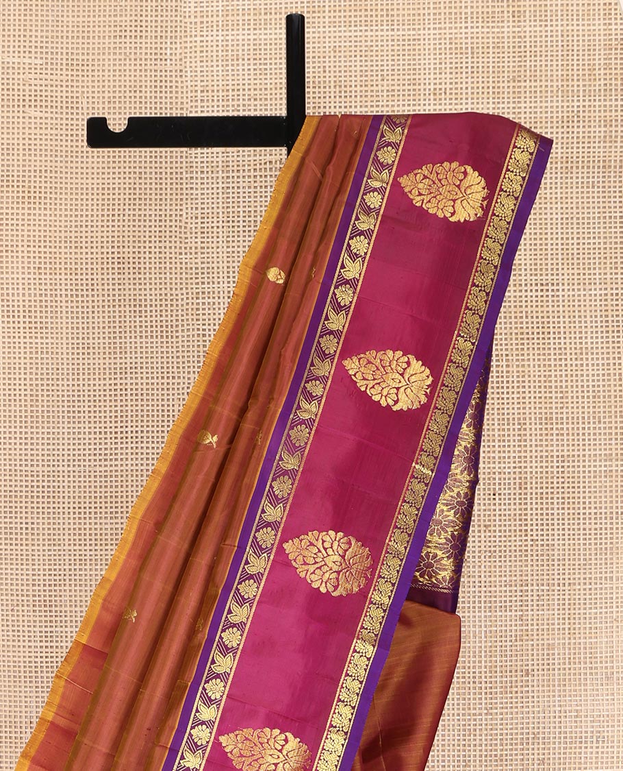 Brown Kanchipuram Silk Saree, Ornamented with Zari Buttas on Its Body, Complemented by a Contrast One-Sided Border of Floral and Peacock Designs, Pallu of Floral Zari Designs, and Comes Without a Blouse