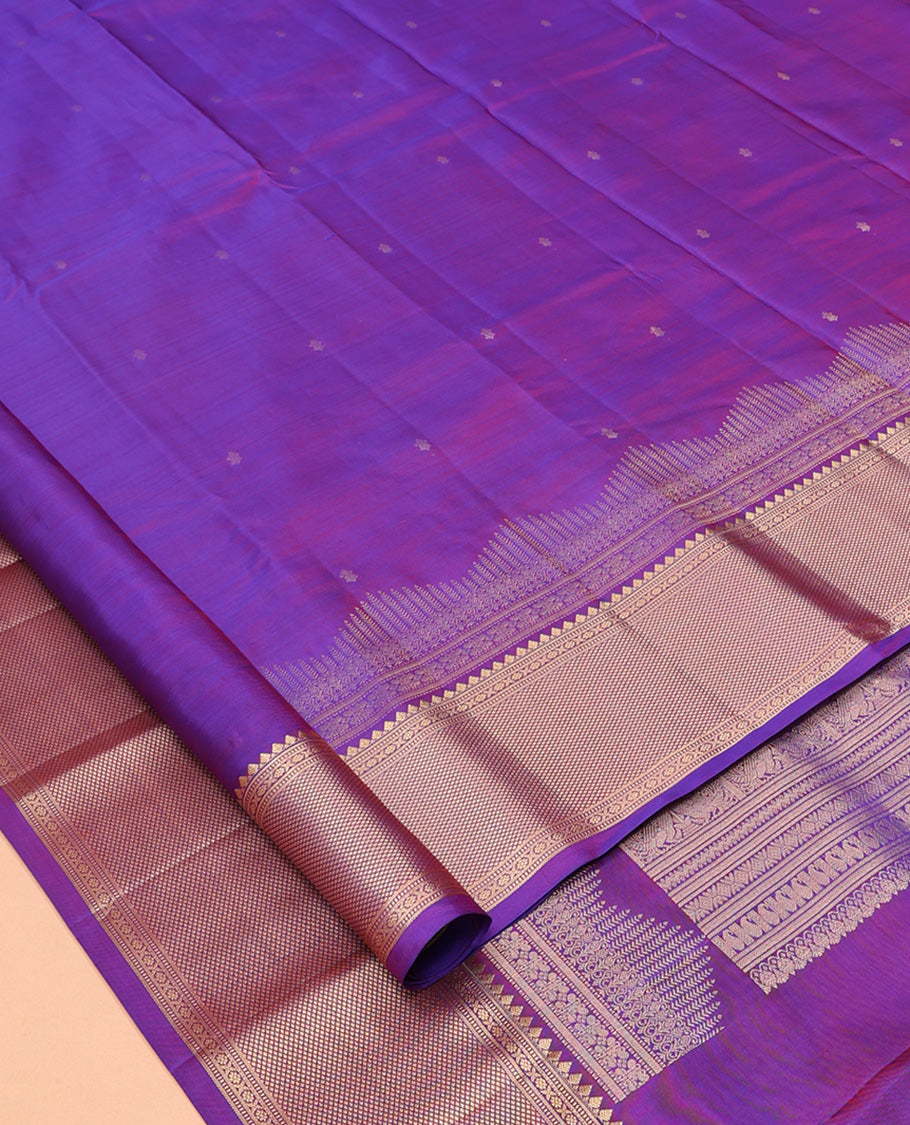 Violet Vasundhara Silk Saree Gracefully Embellished with Zari Buttas, Highlighted by a Zari Border Featuring Thilakam Mokku, Muthu, Cross Kamalam, and Mayil Kann Designs, Elegantly Embellished Pallu, and Paired with a Matching Blouse