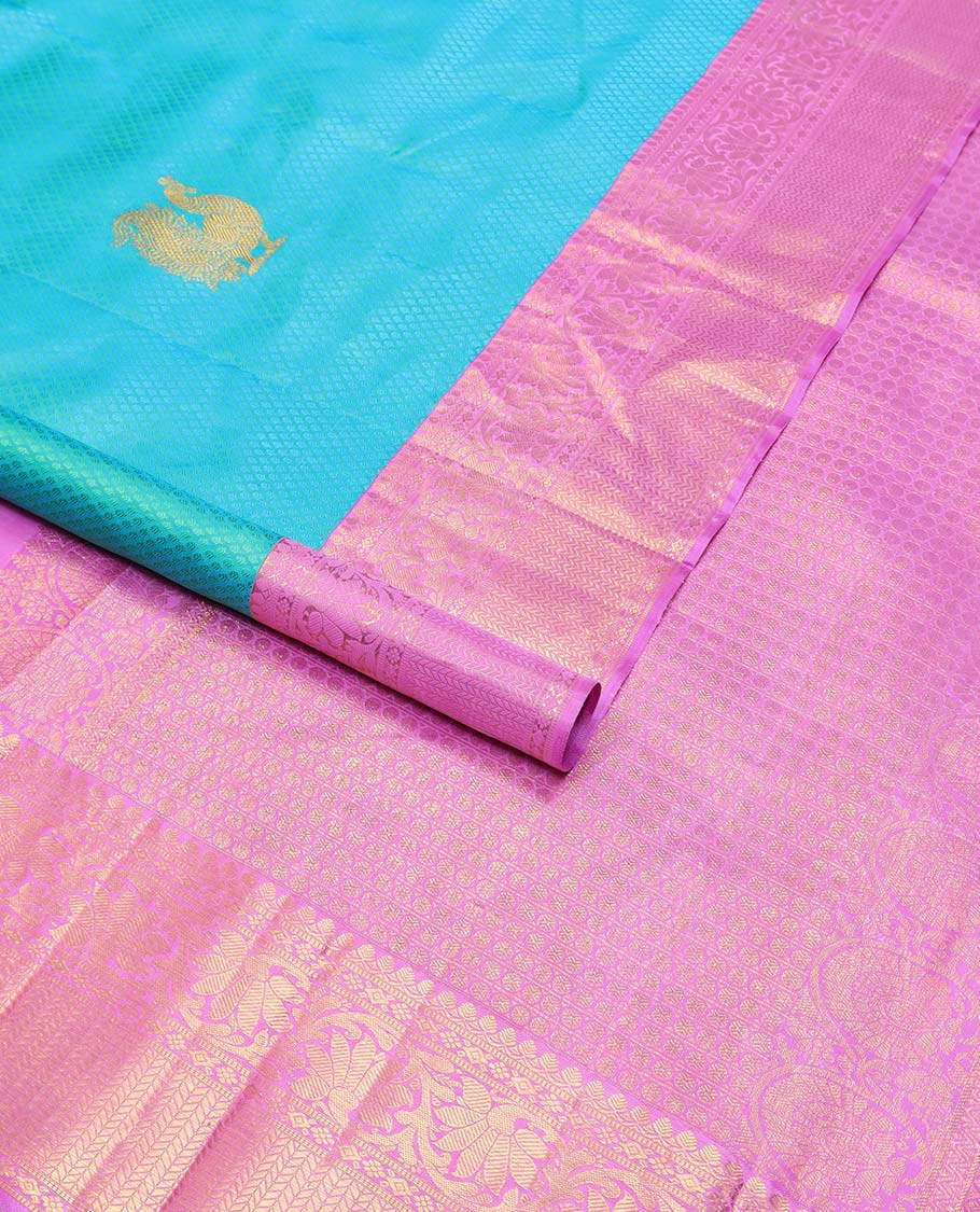 Light blue checked, mayil buttas silk saree with contrast border of thilakam mokku, muthu, paun design & floral design pallu
