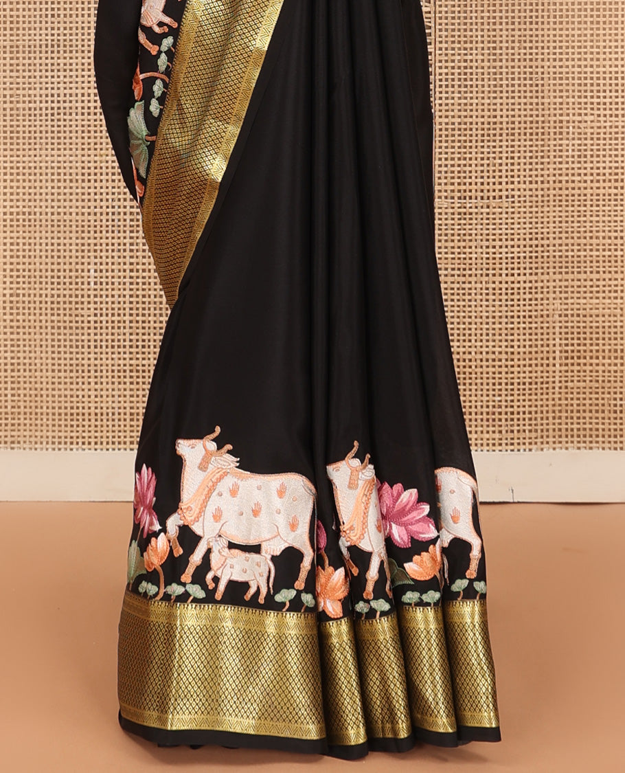 Black delicately thread hand embroidered Mysore silk saree features Pichwai lotus vine, and cow motifs, traditional zari border, and jaal pallu