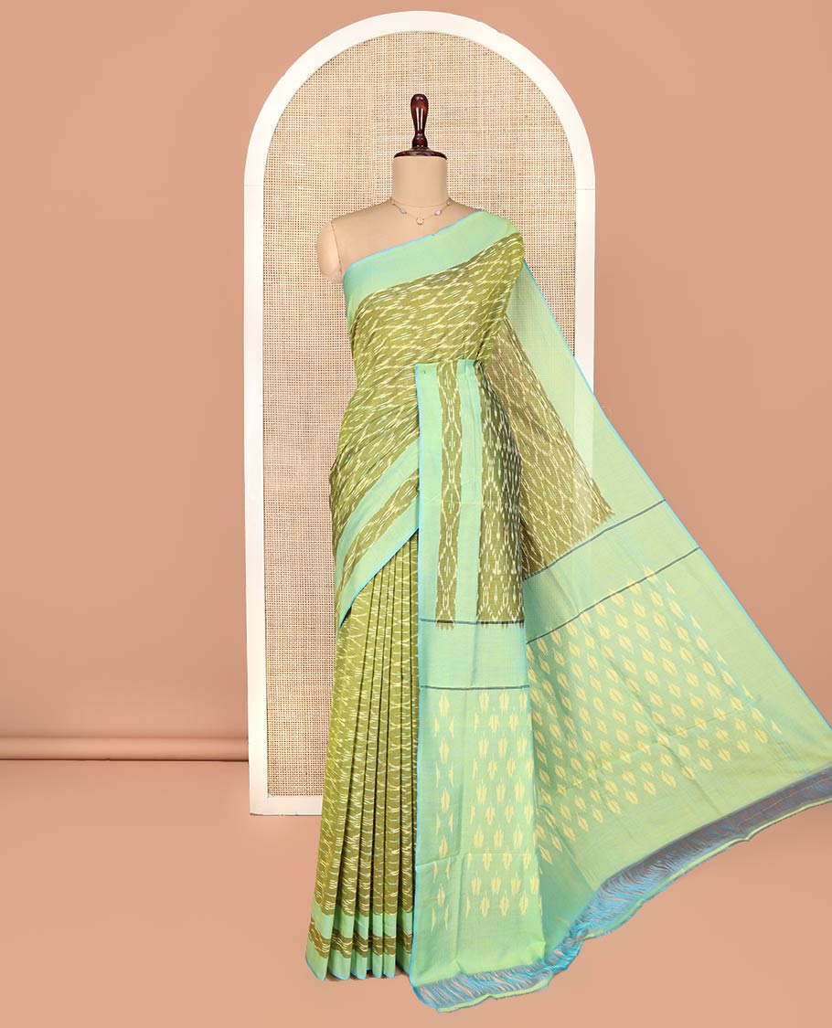 Light Green Ikkat Cotton Saree, Accentuated with Ikkat-Style Ogee Patterns on Its Body, Complemented by a Contrast Ikkat Textured Border, Pallu Steeped with Ikkat-Style Buttas, and Has No Blouse