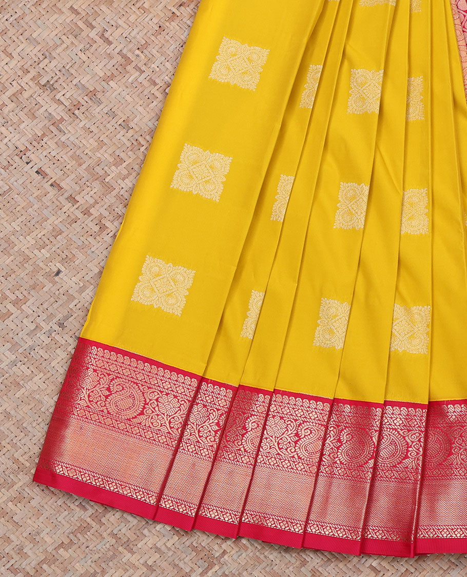 Yellow Budget Silk Saree, Sparsely Sparkled with Buttas All Over Its Body, Complemented by a Contrast Traditional Zari Border of Paisley Designs, Pallu of Rudraksham Butta Enclosed Jaal, and Paired with a Contrast Blouse