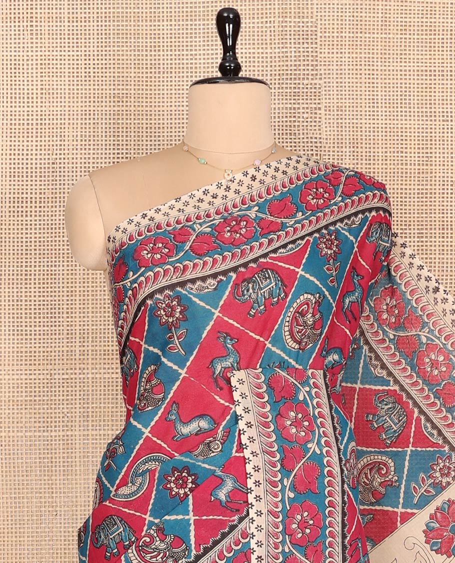 Blue Machine-Printed Kalamkari Cotton Saree Features Butta Enclosed Jaal, Floral Printed Border, Pallu of Peacocks, and a Contrast Blouse