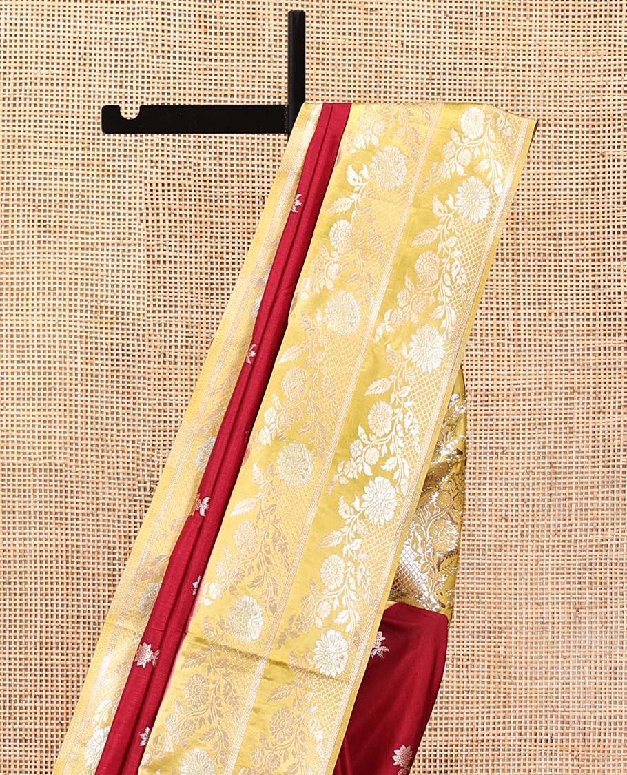 Maroon Mushuru Silk Saree, Elevated with Zari Buttas All Over Its Body, Complemented by Captivating Contrast Border of Floral Jaal Designs, Grandly Decked Up Pallu and Paired with a Contrast Blouse