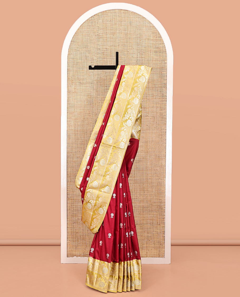 Maroon Mushuru Silk Saree, Elevated with Zari Buttas All Over Its Body, Complemented by Captivating Contrast Border of Floral Jaal Designs, Grandly Decked Up Pallu and Paired with a Contrast Blouse
