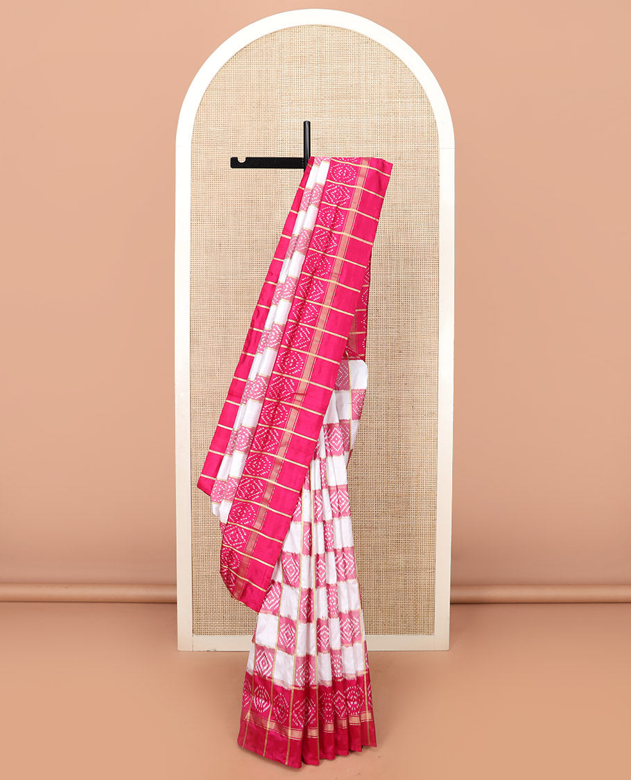 Cream and Pink Ikkat Silk Saree with Ikkat Buttas Enclosed in Checks, Complemented by a Contrast Ikkat Design Border, a Hazily Woven Pallu of Ikkat Patterns, and a Contrast Checked Blouse