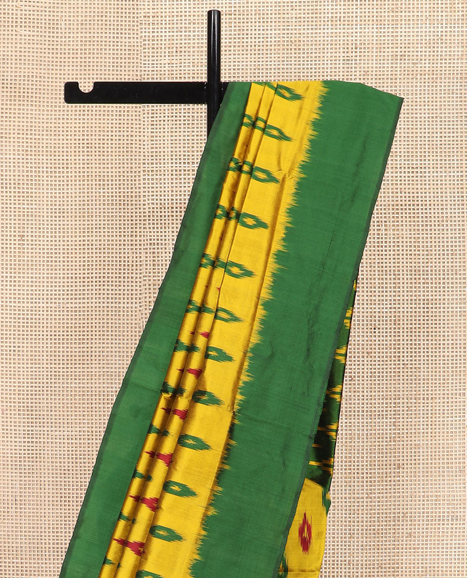 Yellow Ikkat Silk Saree Ornamented with Ikkat Buttas, Featuring a Contrast Plain Border, Complemented by a Pallu Ikkat Woven in an Ogee Pattern