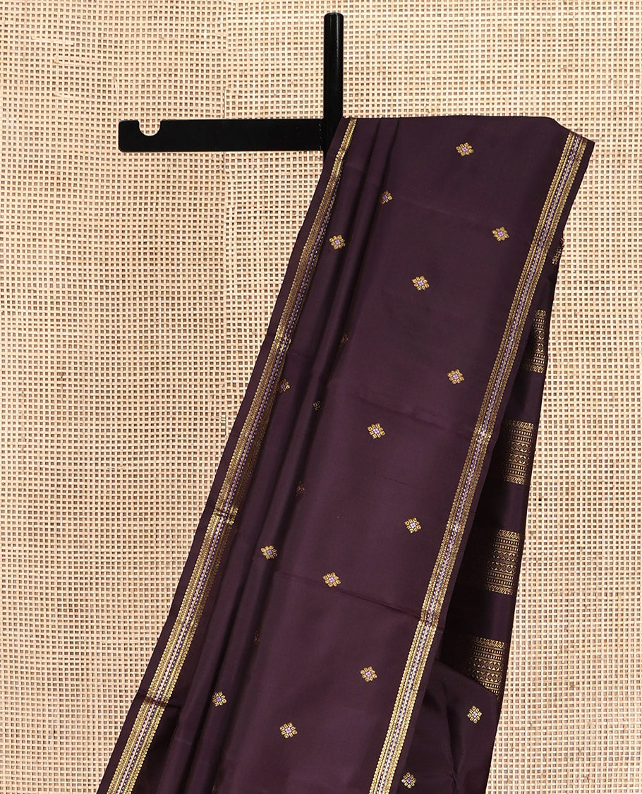 Brown Kanchipuram Silk Saree, Delicately Woven with Zari Buttas All Over Its Body, Highlighted by a Zari Border of Salngai, Muthu, and Rekku Designs, Pallu of Intricate Designs, and Paired with a Matching Blouse